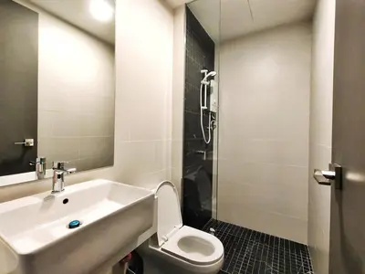 a bathroom with a sink and a toilet at Stunning 2BR with Infinity Pool & City Views in George Town
