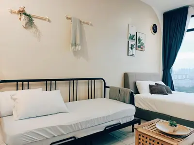 a room with two beds and a table and a window at Stunning 2BR with Infinity Pool & City Views in George Town