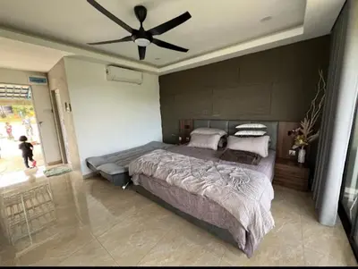 a bedroom with a large bed with a ceiling fan at CBHResort Agrofarm in Kampong Benchah Tualang