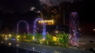 a lit up sign in front of a park at night at CBHResort Agrofarm in Kampong Benchah Tualang