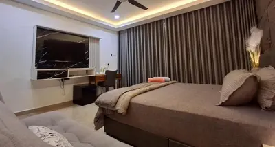 a bedroom with a bed and a desk and a television at CBHResort Agrofarm in Kampong Benchah Tualang