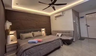 a bedroom with a large bed with a ceiling fan at CBHResort Agrofarm in Kampong Benchah Tualang