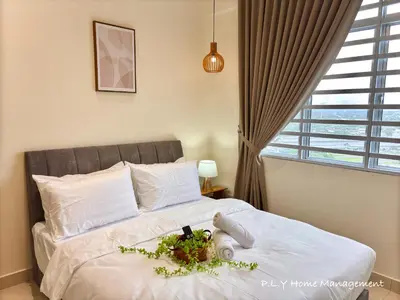 a bedroom with a bed with a flower arrangement on it at Falim Residence Condo Ipoh with 2 Parking in Ipoh