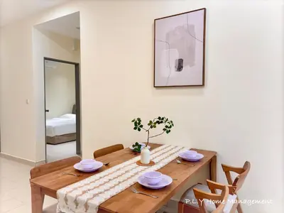 a dining room with a wooden table and chairs at Falim Residence Condo Ipoh with 2 Parking in Ipoh