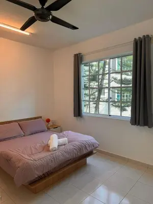 a bedroom with a bed with a ceiling fan at The Trails Of Kampar in Kampar