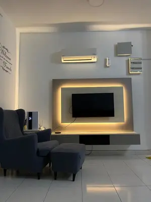 a living room with a flat screen tv on a wall at The Trails Of Kampar in Kampar