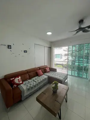 a living room with a brown couch and a table at The Trails Of Kampar in Kampar