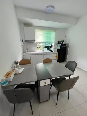 a kitchen with a table and chairs in a room at The Trails Of Kampar in Kampar