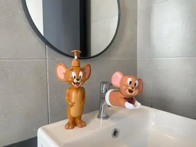 two toy animals sitting on a sink in a bathroom at Tom and Jerry Suite with Infinity Pool in George Town