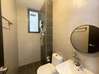 a bathroom with a toilet and a sink and a mirror at Tom and Jerry Suite with Infinity Pool in George Town