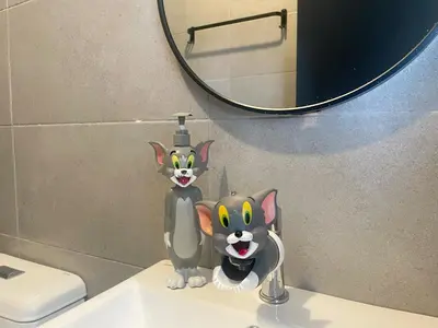 a cat figurine sitting on top of a bathroom sink at Tom and Jerry Suite with Infinity Pool in George Town