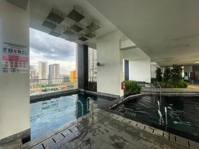 a swimming pool in a building with a view of a city at Tom and Jerry Suite with Infinity Pool in George Town