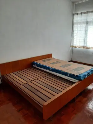 an empty bed in a room with a window at Rumah Teres Teluk Kumbar in Bayan Lepas