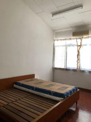 a bedroom with a bed in a room with a window at Rumah Teres Teluk Kumbar in Bayan Lepas