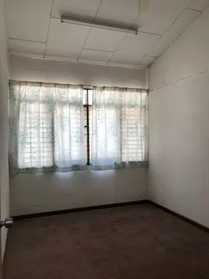 an empty room with a window with white curtains at Rumah Teres Teluk Kumbar in Bayan Lepas