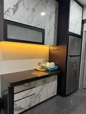 a kitchen with a counter and a refrigerator at Venus Home 3Room Pool,PlayGround,Free Wifi,6Pax in Seri Manjung