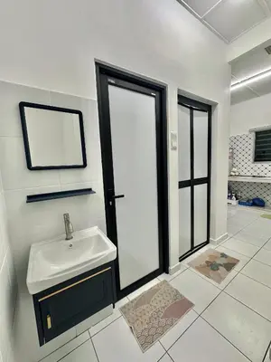 a white bathroom with a sink and a mirror at Urban Eats Stay in Ipoh
