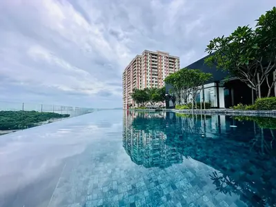 a large pool of water next to a tall building at World Class Apartment In Georgetown 3BR 10pax in Jelutong