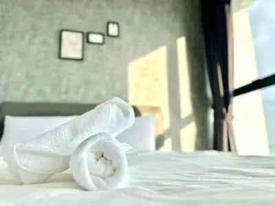a towel sitting on top of a bed at Spacious 3BR Infinity Pool 10pax,Groups & Families 10pax in George Town