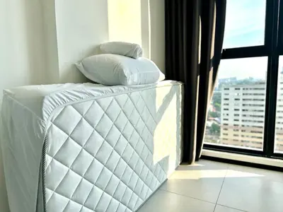 a bed with two pillows on it in a room with a window at Spacious 3BR Infinity Pool 10pax,Groups & Families 10pax in George Town