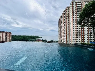 a large pool of water in front of tall buildings at Familystay Home 3BR-10PAX Urban suites in George Town
