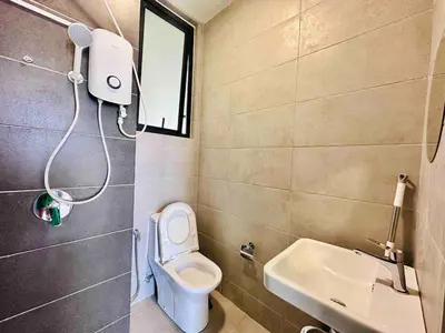 a small bathroom with a toilet and a sink at Familystay Home 3BR-10PAX Urban suites in George Town