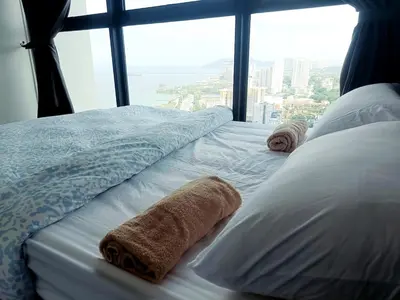 a bed in a room with a large window at Familystay Home 3BR-10PAX Urban suites in George Town
