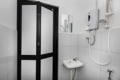 a bathroom with a shower and a sink at Bahari 58 in George Town