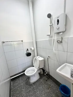 a bathroom with a toilet and a sink at Bahari 58 in George Town