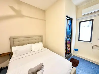 a bedroom with a white bed and a window at Bahari 58 in George Town
