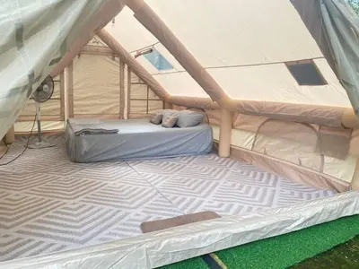 a tent with a bed inside of it at Glamping in Tapah