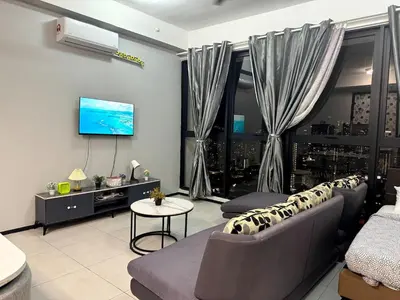 a living room with a couch and a tv at Charming Haven- Relaxing Retreat Nearby Airpor 10pax in George Town