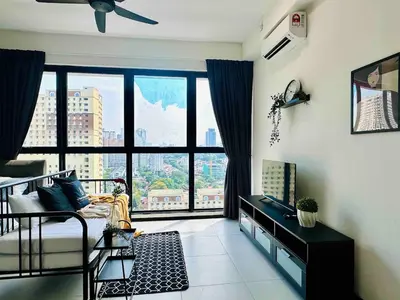 a living room with a bed and a large window at newly renovation apartment 3BR pool 10 pax in George Town