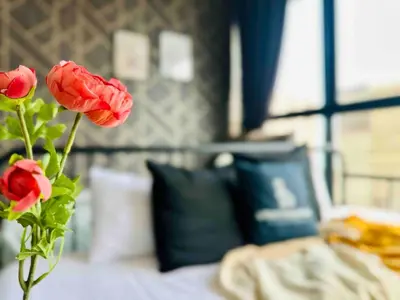 a vase with two red roses on a bed at newly renovation apartment 3BR pool 10 pax in George Town