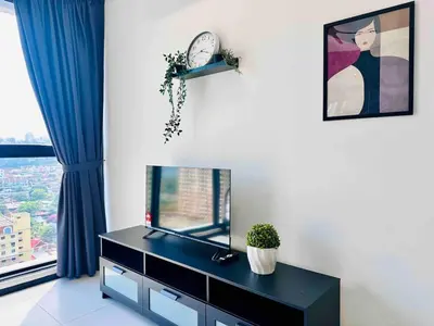 a living room with a tv and a clock on the wall at newly renovation apartment 3BR pool 10 pax in George Town