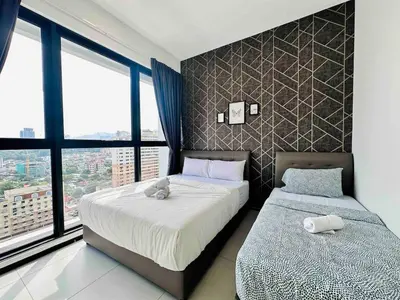 a bedroom with two beds and a large window at newly renovation apartment 3BR pool 10 pax in George Town