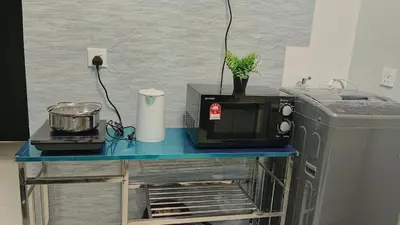 a blue table with a microwave and a refrigerator at Georgetown Komtar Familystay 3BR 10Pax in George Town
