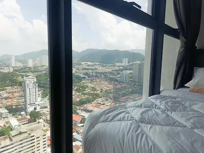 a bedroom with a view of a city from a window at Georgetown Komtar Familystay 3BR 10Pax in George Town