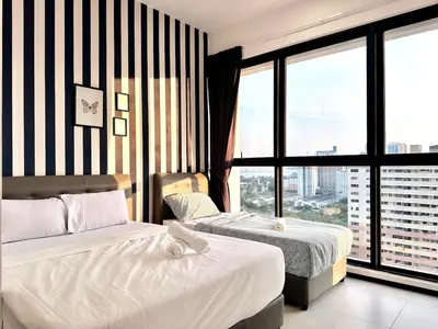 a hotel room with two beds and a large window at cozy luxury suites urban in penang city view 10pax in George Town