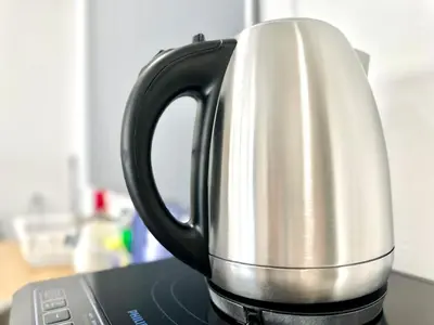 a black and white coffee pot sitting on top of a laptop at cozy luxury suites urban in penang city view 10pax in George Town