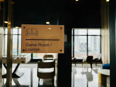 a sign that says game room and lounge at cozy luxury suites urban in penang city view 10pax in George Town