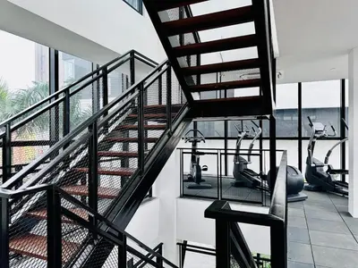 a gym with treadmills and elliptical machines at cozy luxury suites urban in penang city view 10pax in George Town