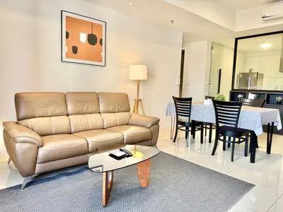 a living room with a couch and a table at Tropicana 218 Macalister #Charm #InfinityPool #WideSeaview #6pax #3BR2bath #1King2Queen #Quality well maintained #Private host in George Town