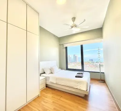 a bedroom with a bed and a large window at Tropicana 218 Macalister #Charm #InfinityPool #WideSeaview #6pax #3BR2bath #1King2Queen #Quality well maintained #Private host in George Town
