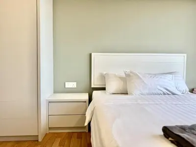 a bedroom with a white bed with a headboard at Tropicana 218 Macalister #Charm #InfinityPool #WideSeaview #6pax #3BR2bath #1King2Queen #Quality well maintained #Private host in George Town