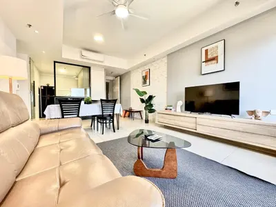 a living room with a couch and a flat screen tv at Tropicana 218 Macalister #Charm #InfinityPool #WideSeaview #6pax #3BR2bath #1King2Queen #Quality well maintained #Private host in George Town
