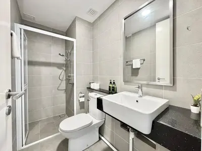 a white bathroom with a sink and a toilet at Tropicana 218 Macalister #Charm #InfinityPool #WideSeaview #6pax #3BR2bath #1King2Queen #Quality well maintained #Private host in George Town