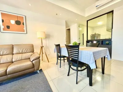 a living room with a couch and a table and chairs at Tropicana 218 Macalister #Charm #InfinityPool #WideSeaview #6pax #3BR2bath #1King2Queen #Quality well maintained #Private host in George Town