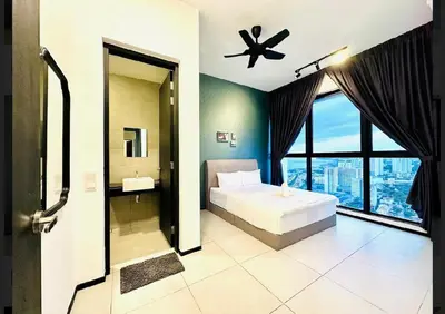 a bedroom with a bed and a bathroom with a window at Comfort Stay Family Home 3BR 10PAX in George Town