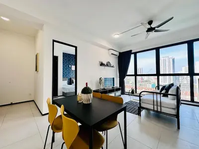 a living room with a table and chairs and a couch at Comfort Stay Family Home 3BR 10PAX in George Town
